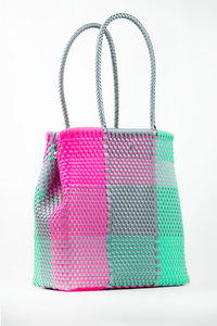 stylish pink. green, and silver bag with two long silver straps to hold it from. it has a magnet at the top to close the bag. made from 100% recycled plastic